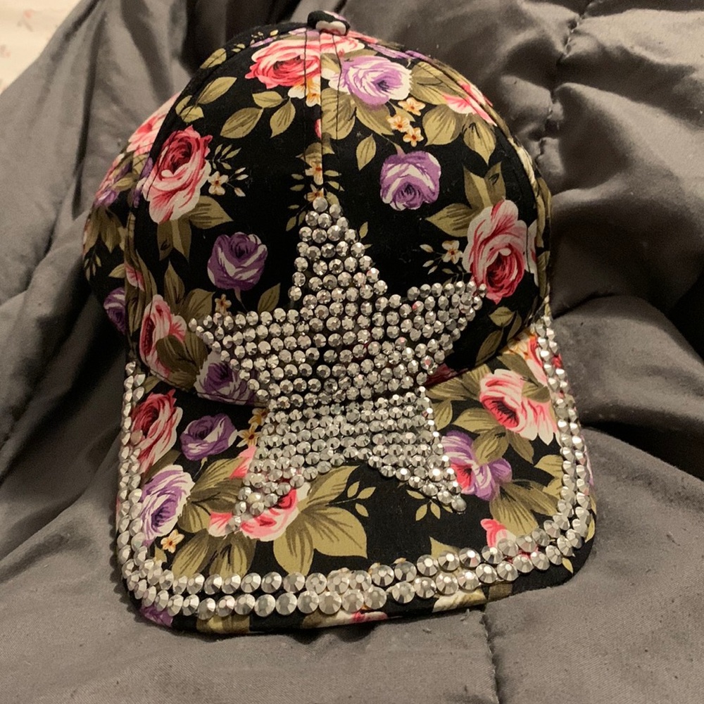a black Magid hat with flowers on it